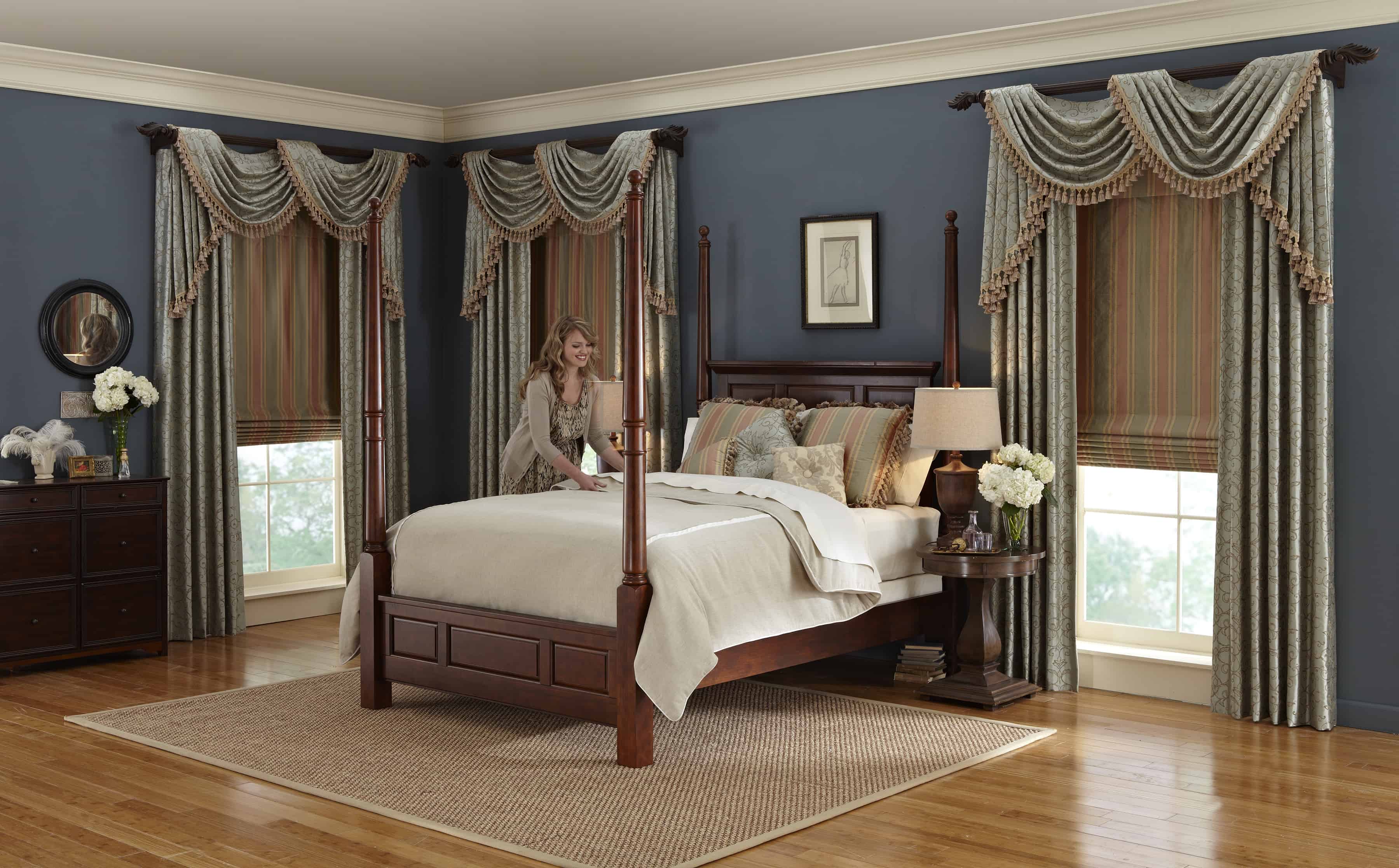 lady making bed with upscale top treatments