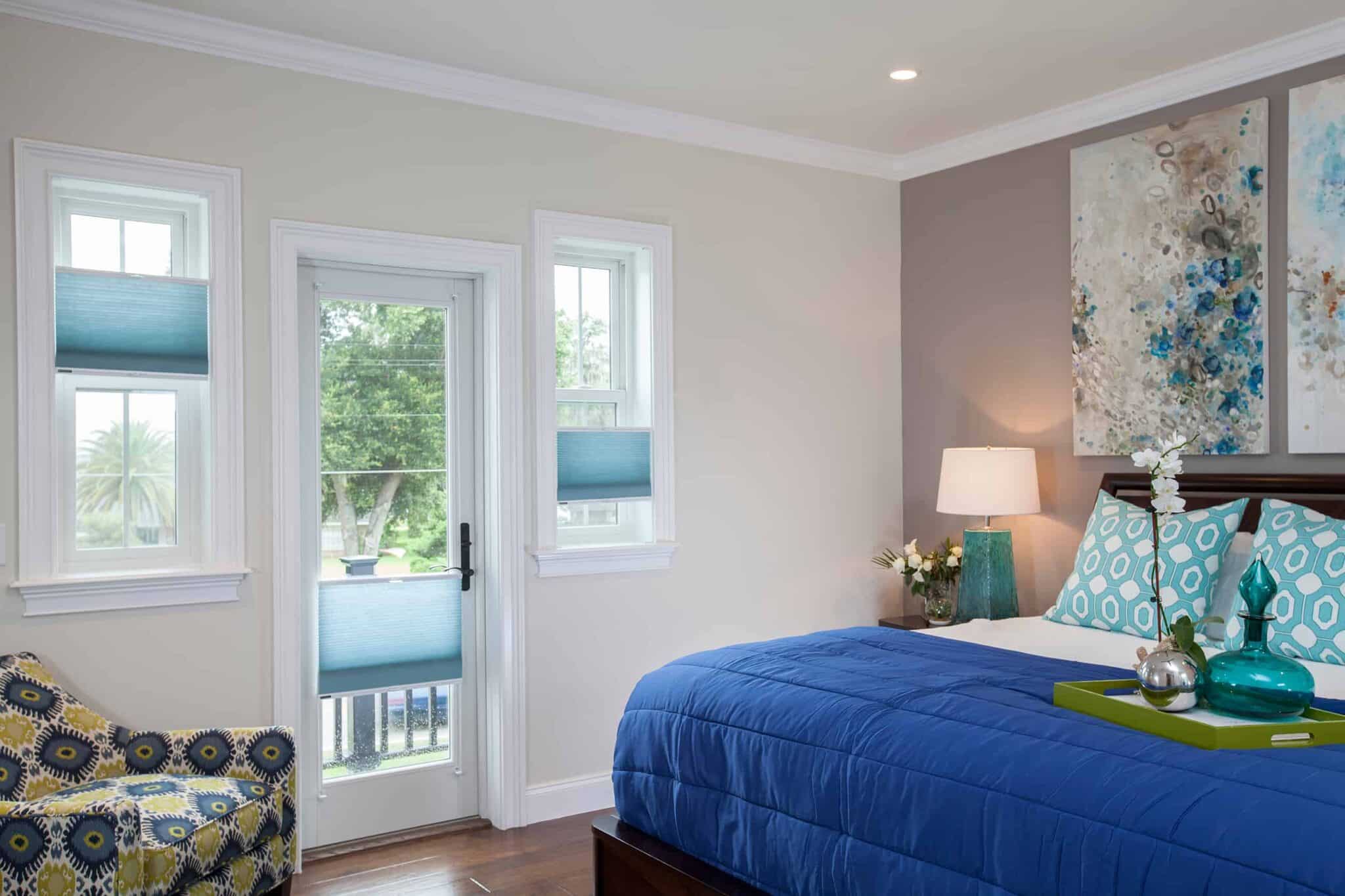 Window Shades 6 Blue cellular shades in a modern bedroom with French door access.