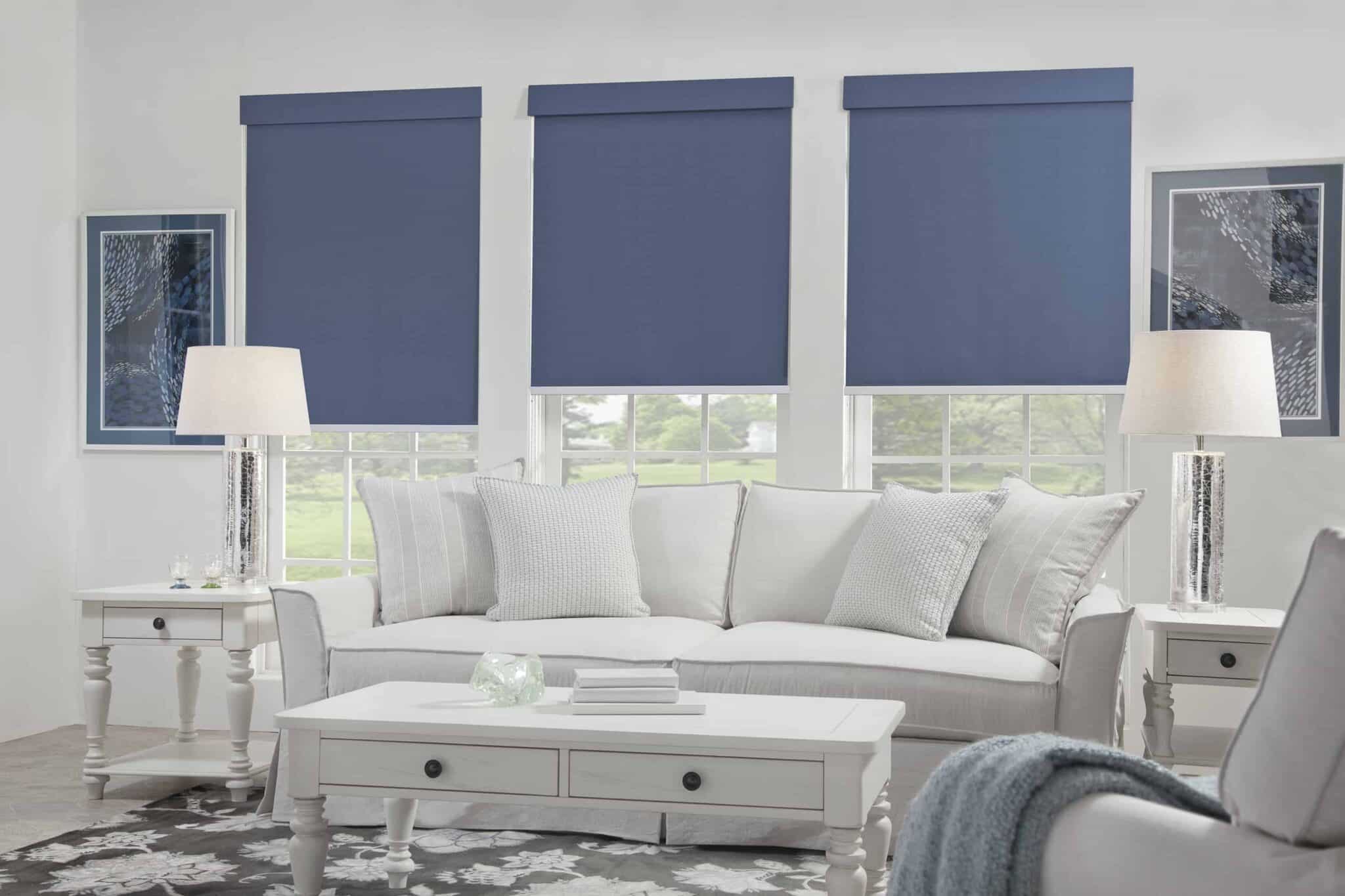 Window Shades 9 Blue roller shades in a serene living room with large windows.