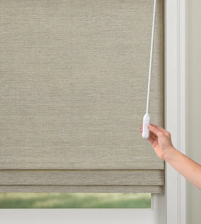 Power Wand for window shades, featuring wand and pendant operation with a button, showcased in a Nicholasville, KY showroom with sleek wooden accents and soft spotlighting.