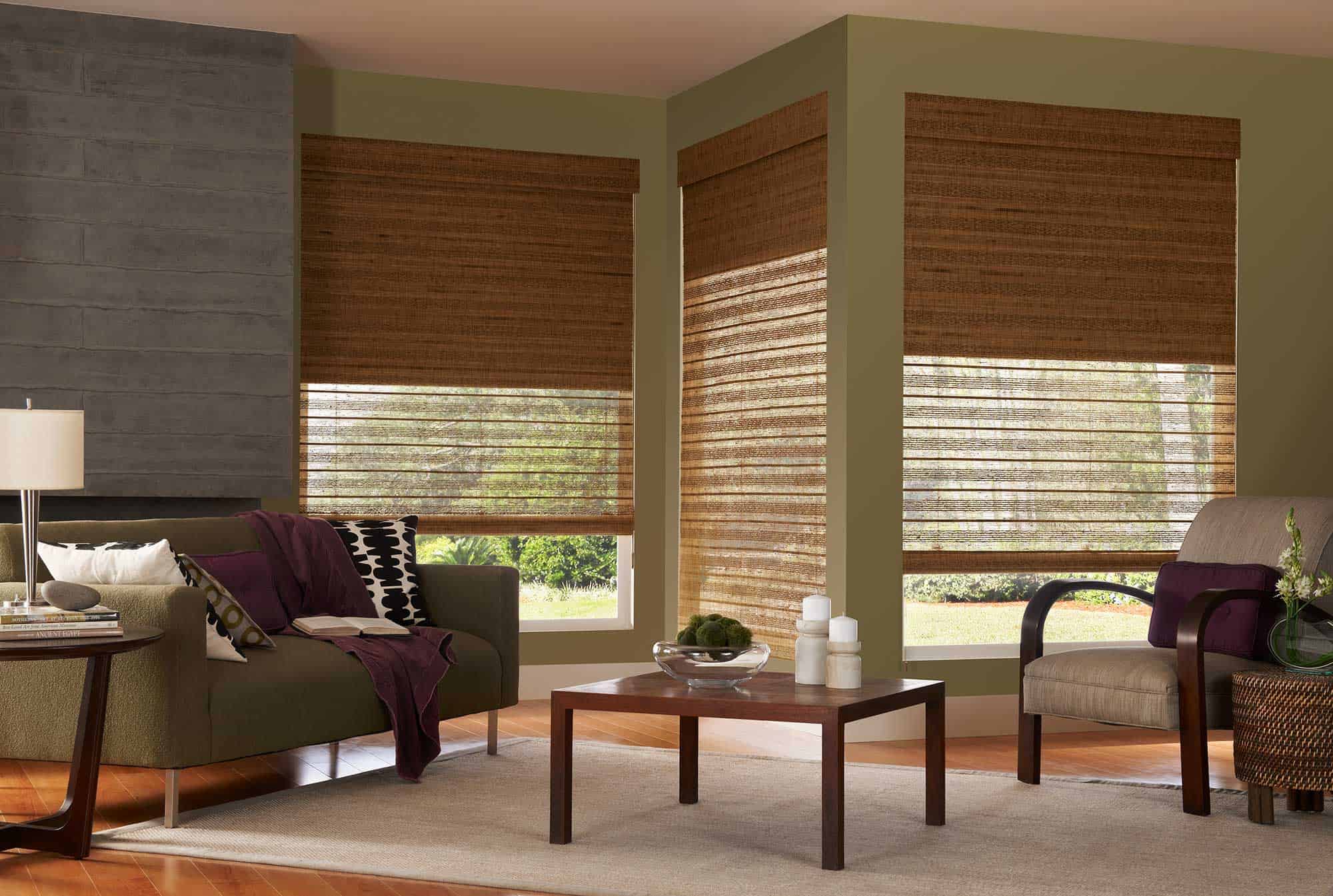 Window Shades 12 Woven wood shades in a cozy living room with large windows.